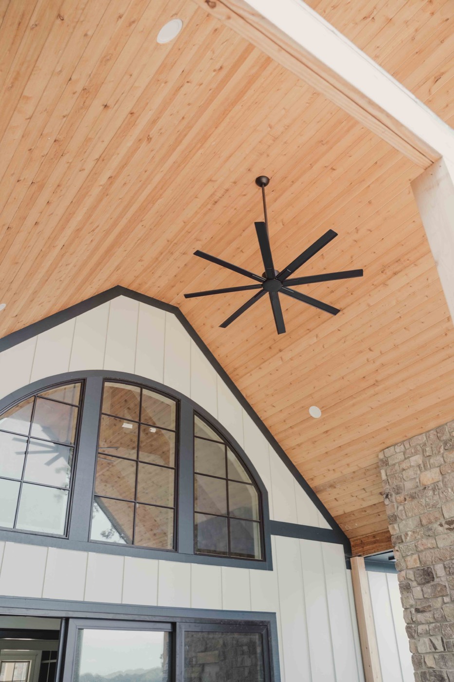 Outdoor living porch with tongue-and-groove ceiling and black fan
